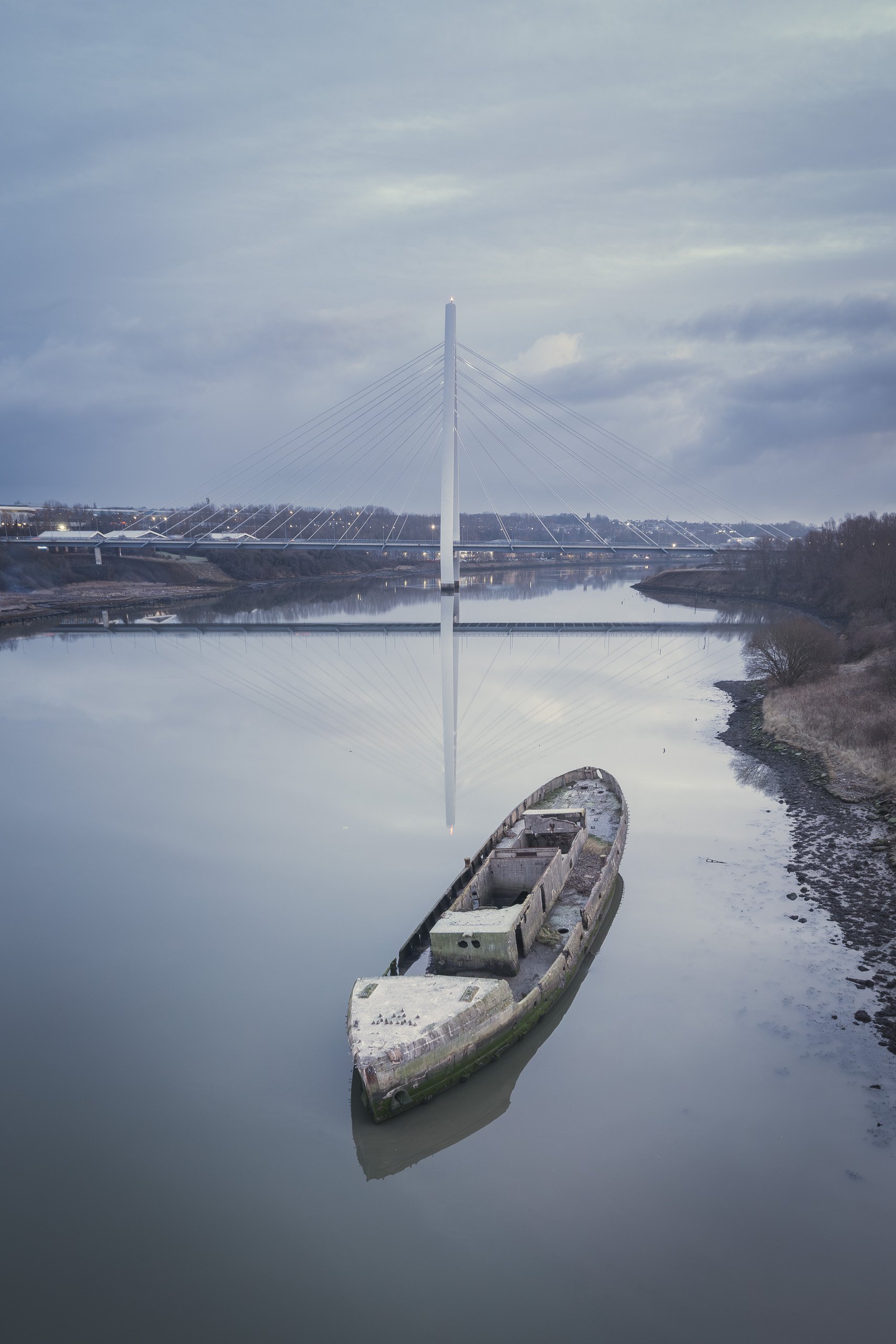 Aerial view of the Northern Spire Bridge with a shipwreck visible nearby