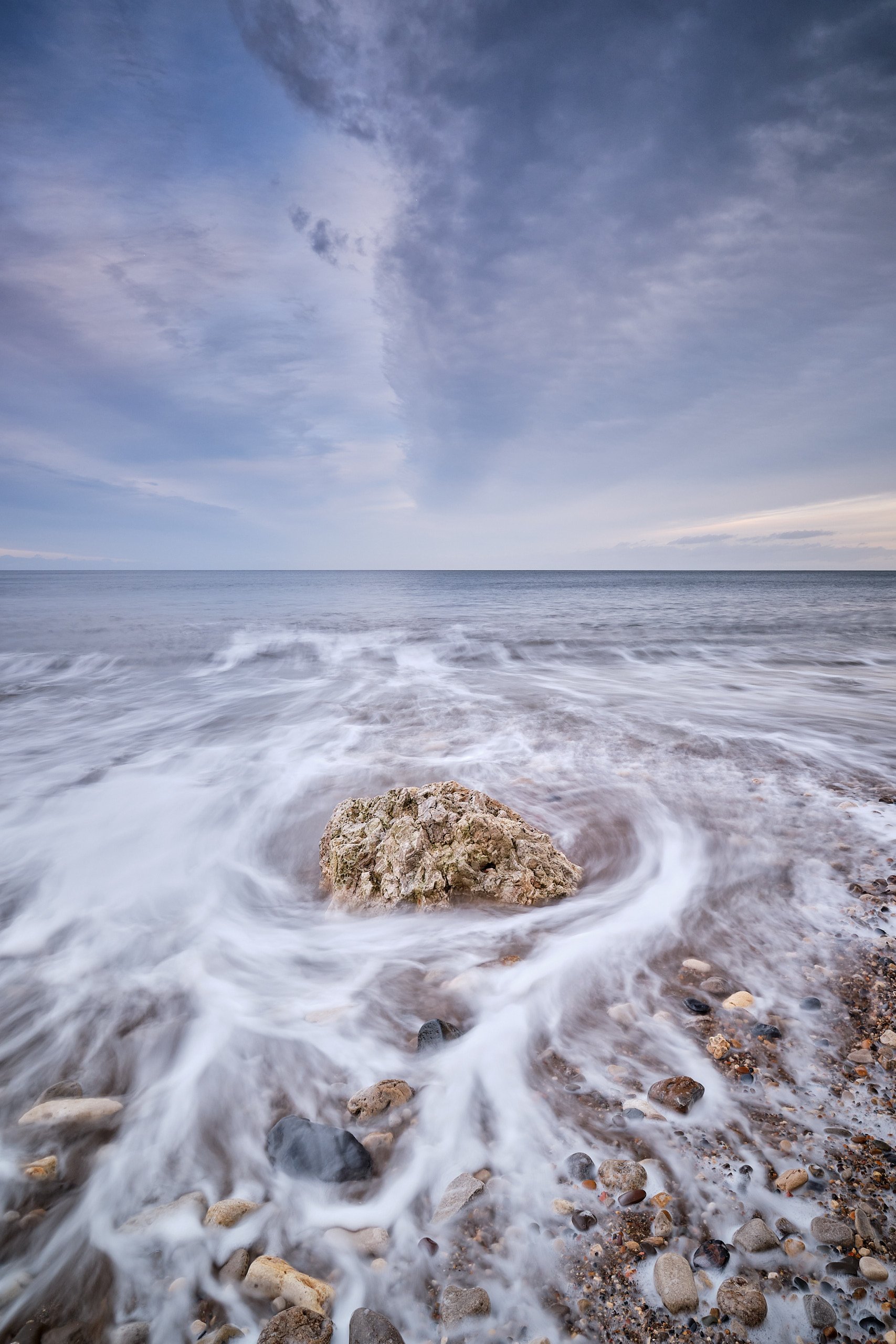 Long exposure of tide swirling around rocks on Easington beach